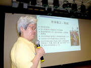 A volunteer sharing on stage