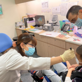 optometrist conducting vision screening for a child