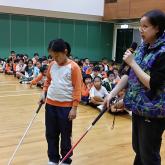 Visually impaired public education ambassador sharing with students at school