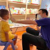 Optometrists conduct vision screening for kindergarten student