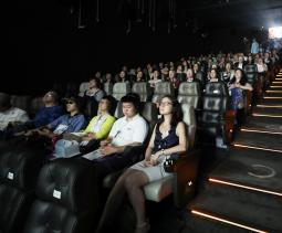 Visually impaired audiences watching a movie with other audiences