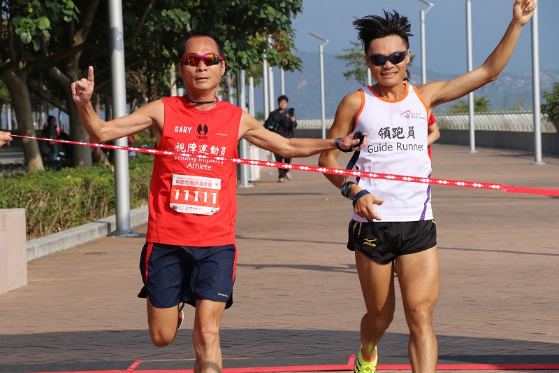 Visually impaired runner Gary (left) crossed the finish line together with his guide runner, Nick