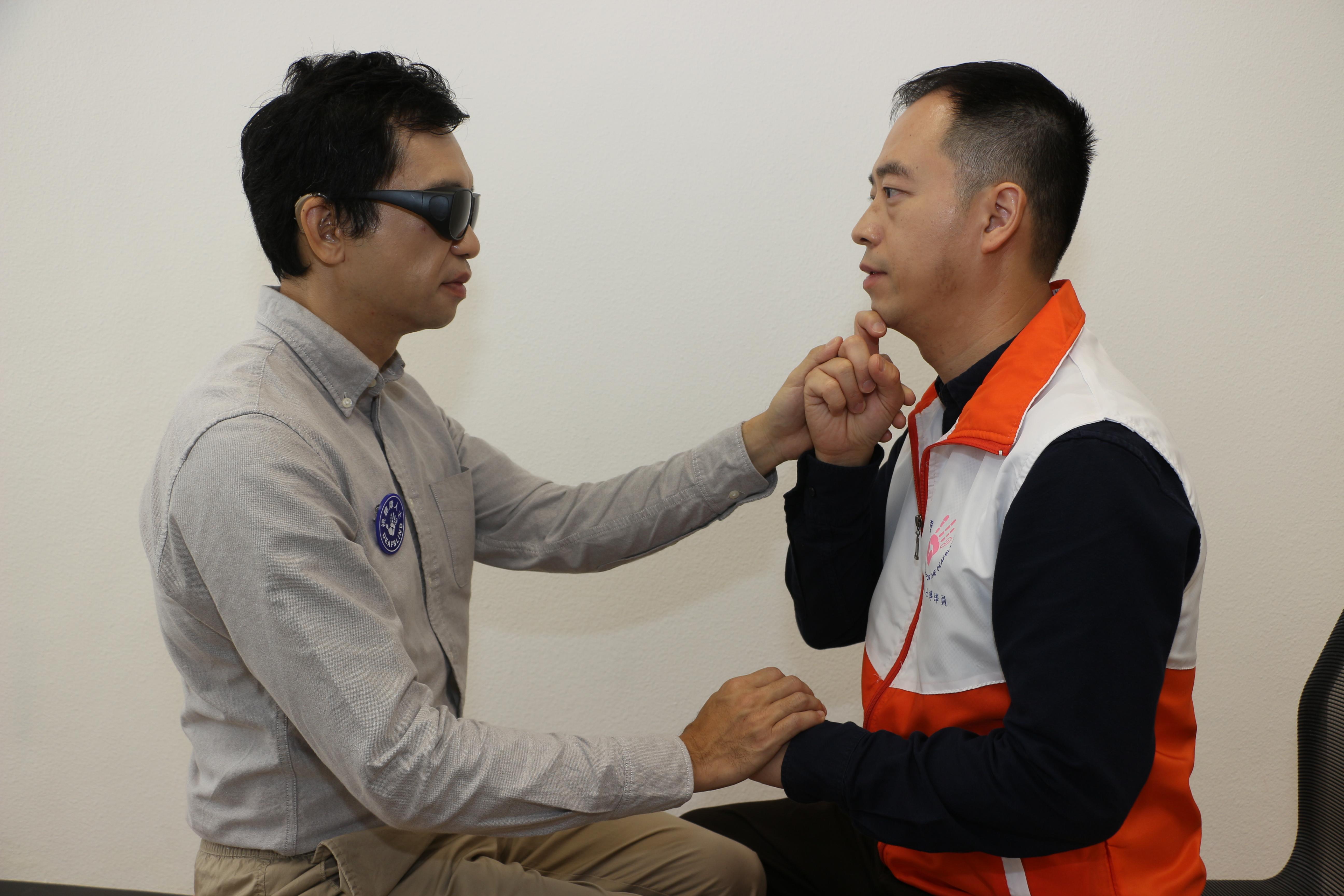 Communicator guides facilitate communication between the deafblind and other people by using tactile sign language.