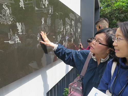 A visually impaired (left) and a volunteer watching the mural 