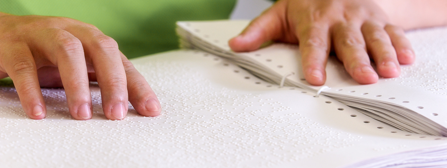 A hand touching braille 